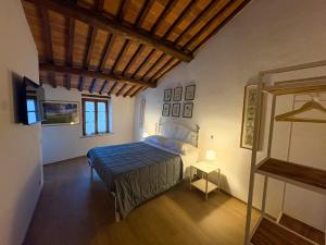 a bedroom with a bed and a wooden ceiling at Tuscany Charme Apartments in Asciano