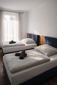 two beds with stuffed animals on them in a bedroom at ApartDays Sarstedt in Sarstedt