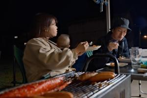 two people sitting at a table eating food at 古民家宿Tabi湊 in Hitachinaka