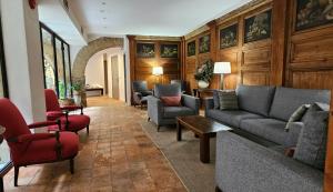a living room with couches and chairs at Hotel de La Font Peralada in Peralada