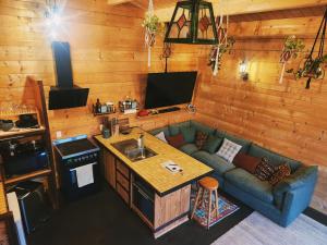 a living room with a couch and a kitchen at Twizel Ecostays in Twizel
