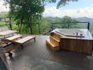 a jacuzzi tub on a deck with a view at Domo Alto del Monte in Alto del Monte