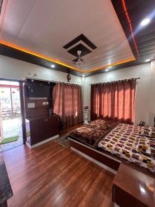a bedroom with a large bed and wooden floors at Mount view guest house in Mukteshwar +55 photos