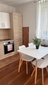 a white dining room table and chairs in a kitchen at Lena in Jajce