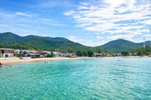 a beach with a group of people in the water at Beachfront 4BR Villa with Private Pool - Ocean Access in Chaloklum