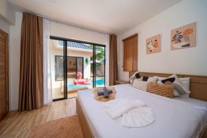 a bedroom with a large bed with a large window at Mango Breeze Villa in Ban Nong Chaeng +94 photos
