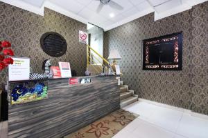a restaurant with a counter and stairs in a room at Hotel D'Sea Princess in Tanjung Bungah