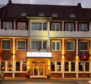 a building with a sign for a hotel at Schäfers Hotel in Cloppenburg
