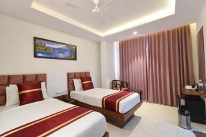 a hotel room with two beds and a window at Hotel Prowell Apex - Kondapur in Hyderabad +56 photos