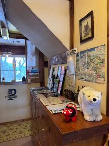 a counter with a stuffed polar bear on top of it at Polar Bear 藏王白熊民宿 in Kaminoyama
