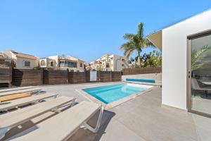 a swimming pool in a villa with a patio at Villa Ella in Eilat
