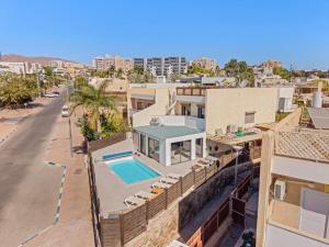 a house with a swimming pool on top of a building at Villa Ella in Eilat