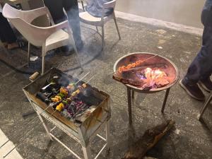 a grill and a bbq with meat and flames at Namya Villas in Bhīm Tāl