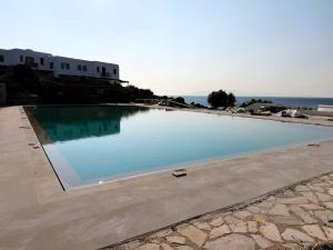 a large swimming pool in front of a building at Bluewave Lux house in Ornos