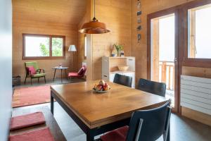 a dining room with a wooden table and chairs at Labbrunnu OG in den Walliser Alpen in Rosswald +31 photos