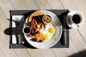 a plate of breakfast food with eggs and fruit at Thundi Ocean View in Maalhos