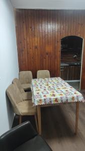 a table and a chair with a cloth on it at Апартамент Луиза in Varna City +21 photos