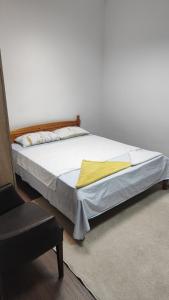 a bedroom with a bed with a yellow blanket on it at Апартамент Луиза in Varna City