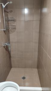 a bathroom with a shower with a toilet at Апартамент Луиза in Varna City