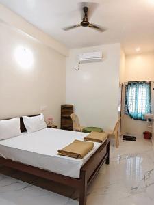 a bedroom with a bed and a ceiling fan at AalaGo in Thiruchendur +16 photos