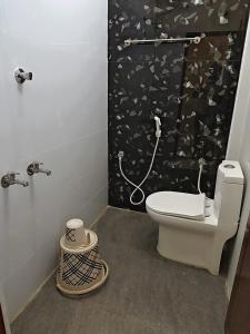 a bathroom with a toilet and a shower at AalaGo in Thiruchendur