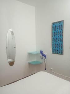 a bathroom with a mirror and a hair dryer at Old house in Tarrafal