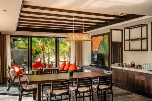a kitchen and dining room with a table and chairs at Amiana Resort Cam Ranh in Cam Ranh