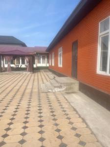 an empty courtyard in front of a building at Dos in Kapchagay