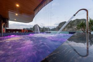 a hot tub with a waterfall in a building at Cycad cruise in Ha Long