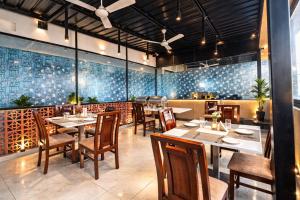 a dining room with tables and chairs in a restaurant at Hotel Prowell Apex - Kondapur in Hyderabad
