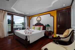 a bedroom with a large bed and a chair at Cycad cruise in Ha Long +49 photos