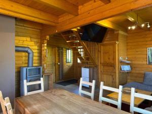 a dining room with a table and a staircase in a log cabin at Blockhaus, Bad Sachsa in Steina