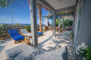 a patio with chairs and a view of the ocean at Patara Evleri in Patara