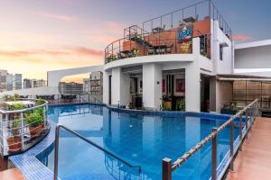 a swimming pool on the roof of a building at Hotel Senses in Kolkata