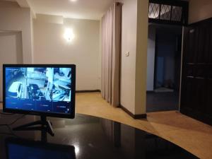 a television sitting on a stand in a room at Villa i in Dehiwala