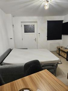 a room with a bed and a tv and a table at Studio Albert 1er in Oye-Plage