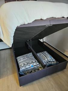 two drawers under a bed with a mattress at Studio Albert 1er in Oye-Plage
