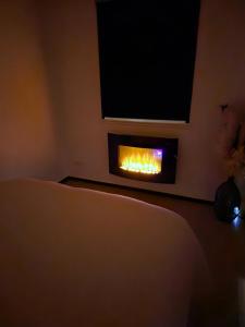 a living room with a fire in the wall at Studio Albert 1er in Oye-Plage