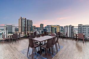a table and chairs on the roof of a building at Hotel Senses in Kolkata