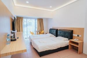 a bedroom with a large bed and a desk at Hotel Koperasi in Seria +9 photos