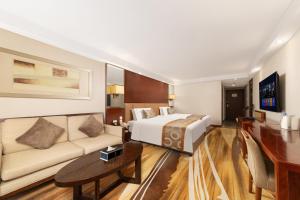 a hotel room with a bed and a couch at Jianguo Hotel Xi'an in Xi'an
