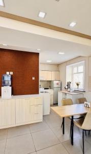 a large kitchen with a wooden table and chairs at Khongor Guest house & Tours in Ulaanbaatar