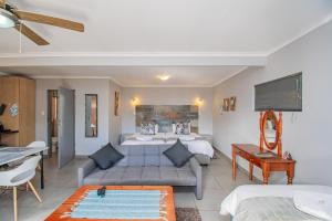 a hotel room with a bed and a desk at Glen Maine Guest House in Pretoria