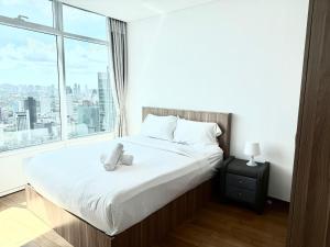 a bedroom with a bed with a teddy bear on it at Vortex Suites KLCC by Chia in Kuala Lumpur +58 photos