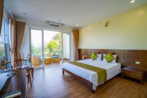 a hotel room with a bed and a balcony at Hải Tiến Resort in Mỹ Ðuc +51 photos