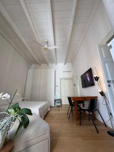 a bedroom with two beds and a desk in it at B&B 102 in Taranto