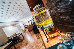 a glass jar filled with yellow liquid sitting on a table at Hostal Cortés in Cuenca