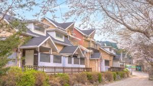 a row of houses with gray roofs on a street at Gapyeong Haneuldari pet pension in Gapyeong