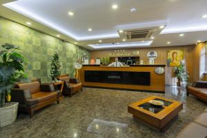 a lobby with a waiting room with chairs and a counter at Hotel Atabay in Istanbul