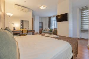 a bedroom with a large bed and a living room at Hotel Atabay in Istanbul